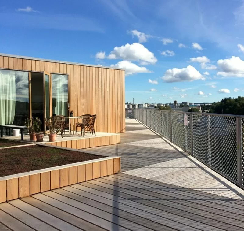 Elegant trævinduer på tagterrasse med udsigt over byen.